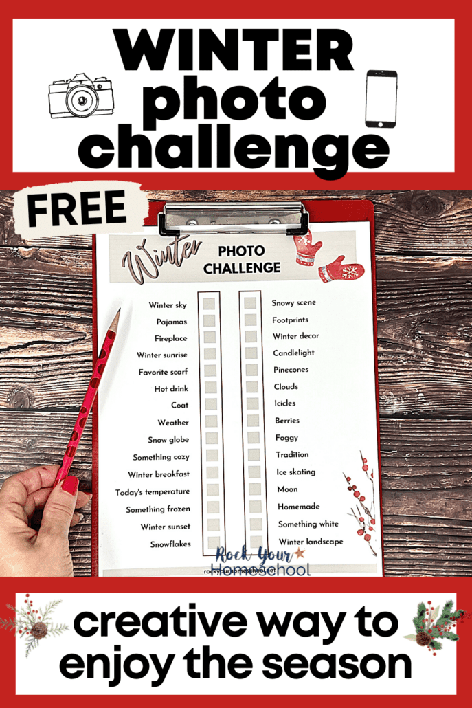 woman holding free printable winter photo challenge on red clipboard with red pencil on wood background