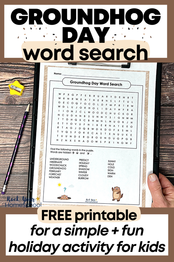 woman holding free printable Groundhog Day word search on black clipboard with purple pencil and yellow star pencil sharpener on wood background