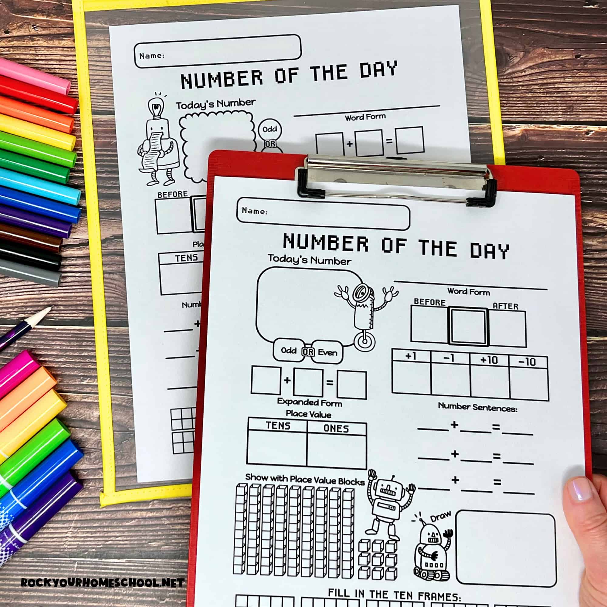 Woman holding clipboard with number of the day worksheets.