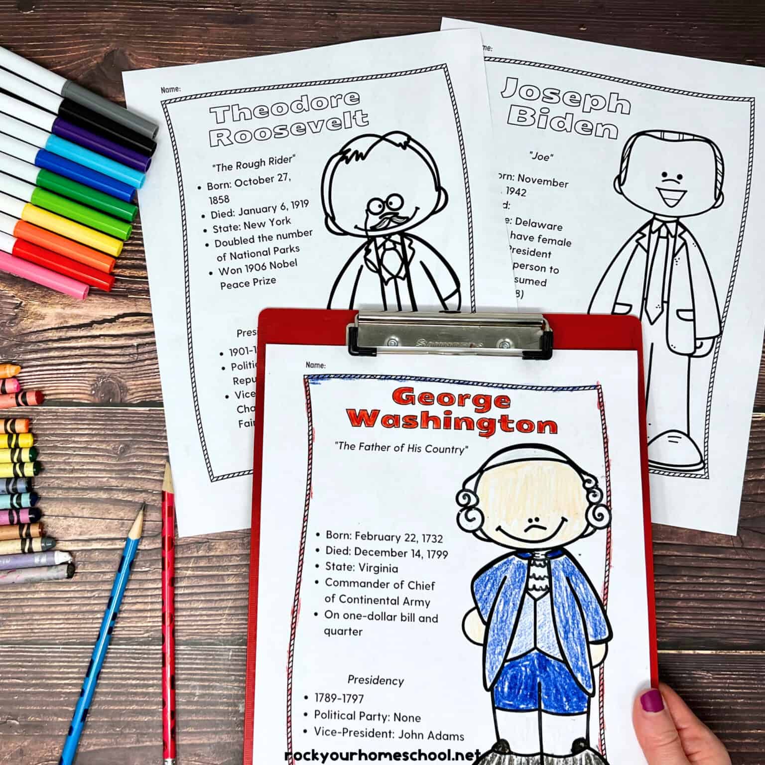 George Washington coloring page on red clipboard with Theodore Roosevelt and Joseph Biden as other examples of these free printable American Presidents coloring pages with rainbow of markers, crayons, and pencils on wood background.