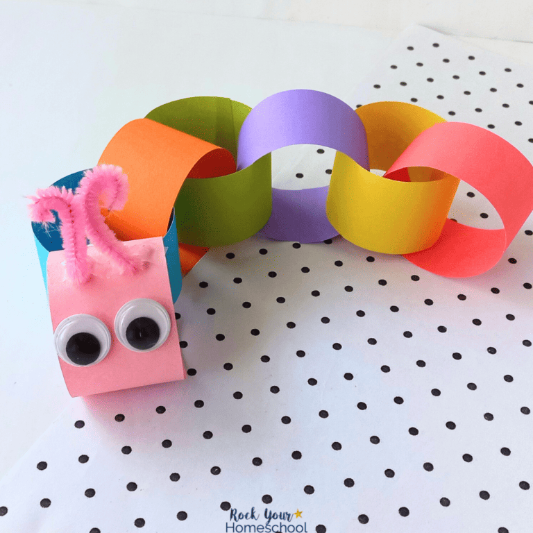 Examples of paper chain caterpillar craft in rainbow of colors with googly eyes and pink pipe cleaner antennae.