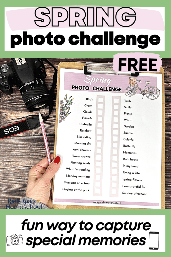 woman holding free printable spring photo challenge on clipboard with pink glitter pencil and camera on wood background
