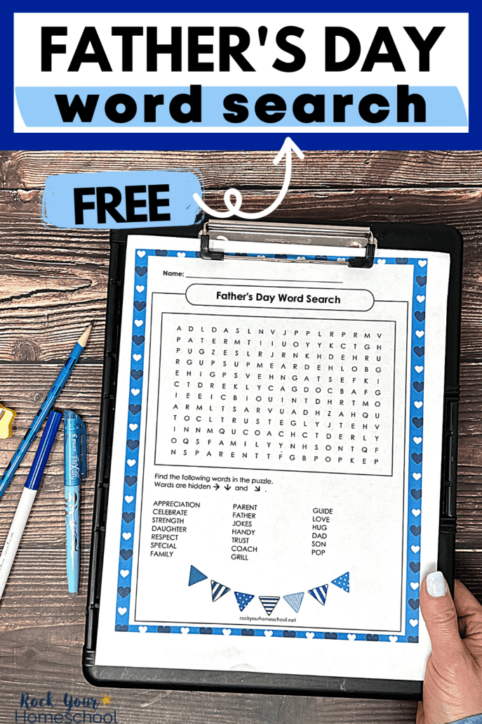 woman holding black clipboard with free printable Father's Day word search.