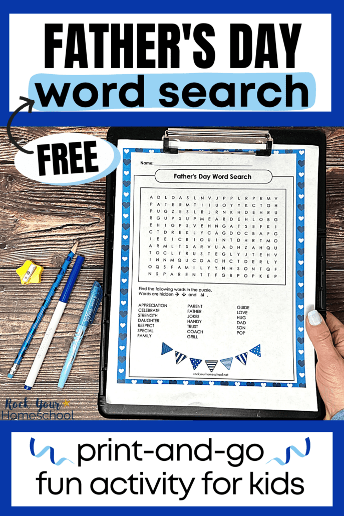 woman holding black clipboard with free printable Father's Day word search