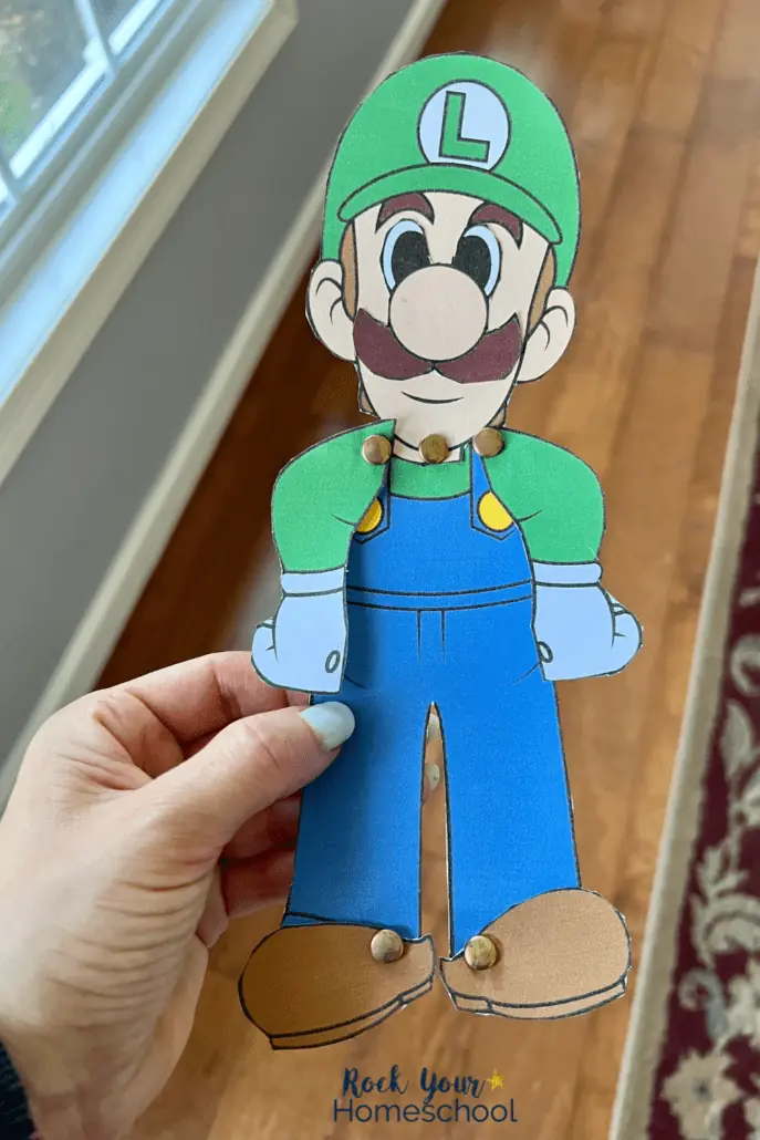 woman holding example of Luigi craft with brads