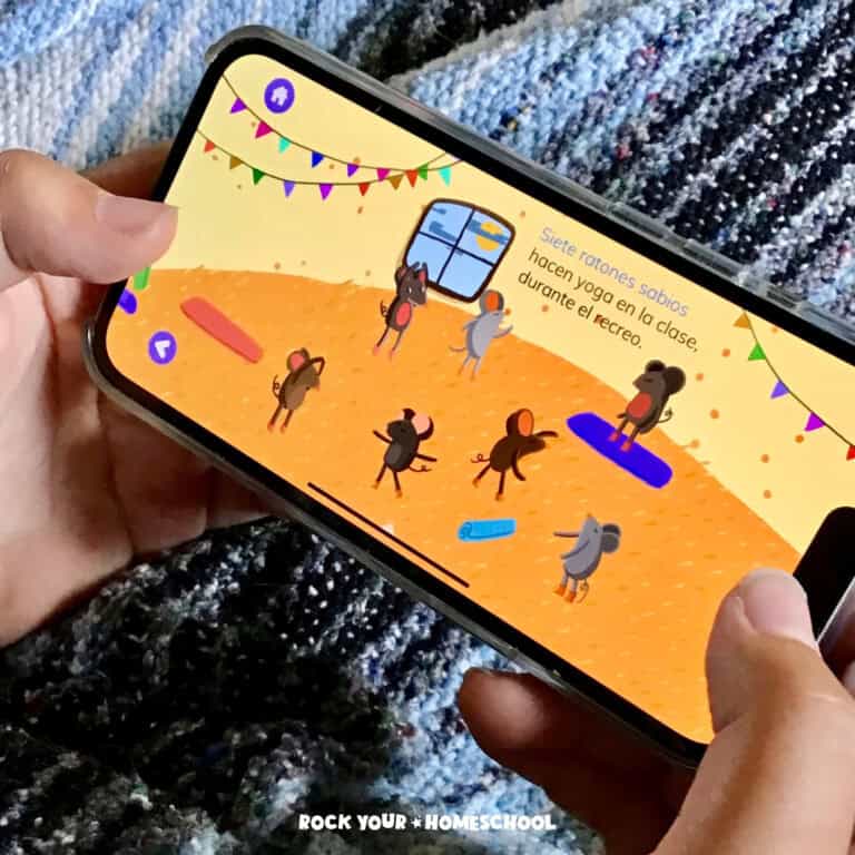 Boy holding iPod and playing FabuLingua, the best app to learn Spanish.