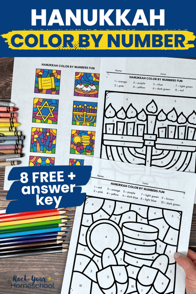 Woman holding examples of free printable Hanukkah color by number printable pages with crayons and color pencils.