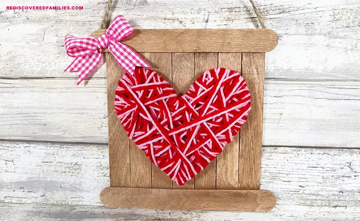 Yarn-wrapped heart craft for kids.
