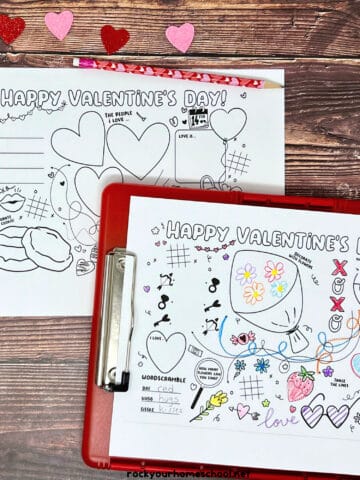 Examples of the free printable Valentine's Day activity sheets on red clipboard with crayons, color pencils, and glitter hearts.