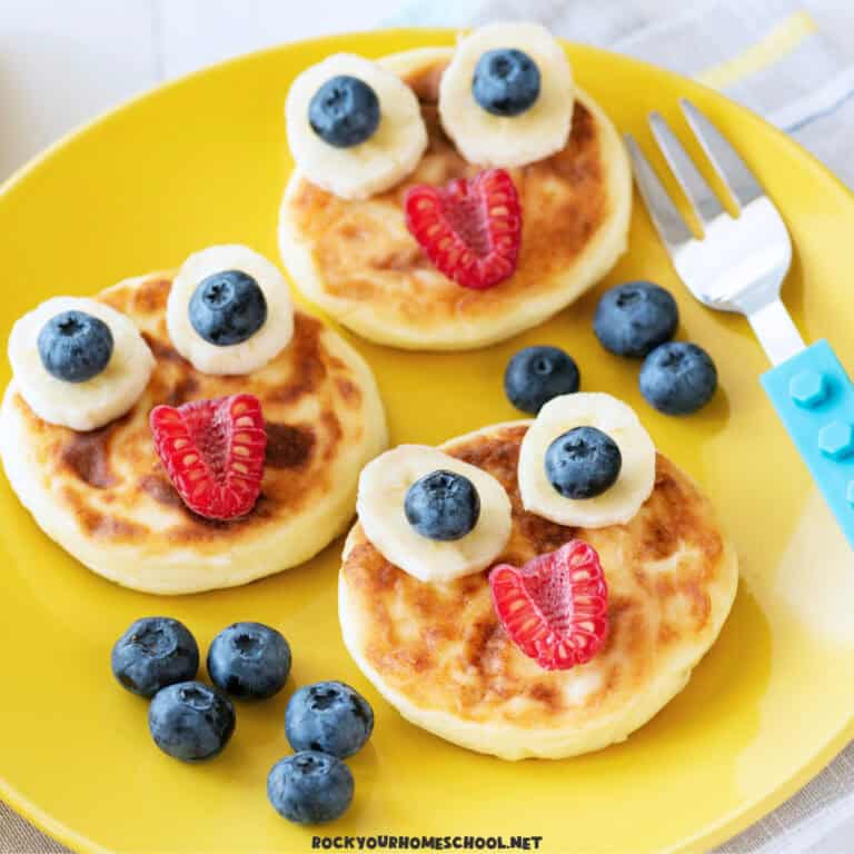 Mini pancakes with cute fruit faces as an example of these easy and healthy homeschool breakfast ideas.