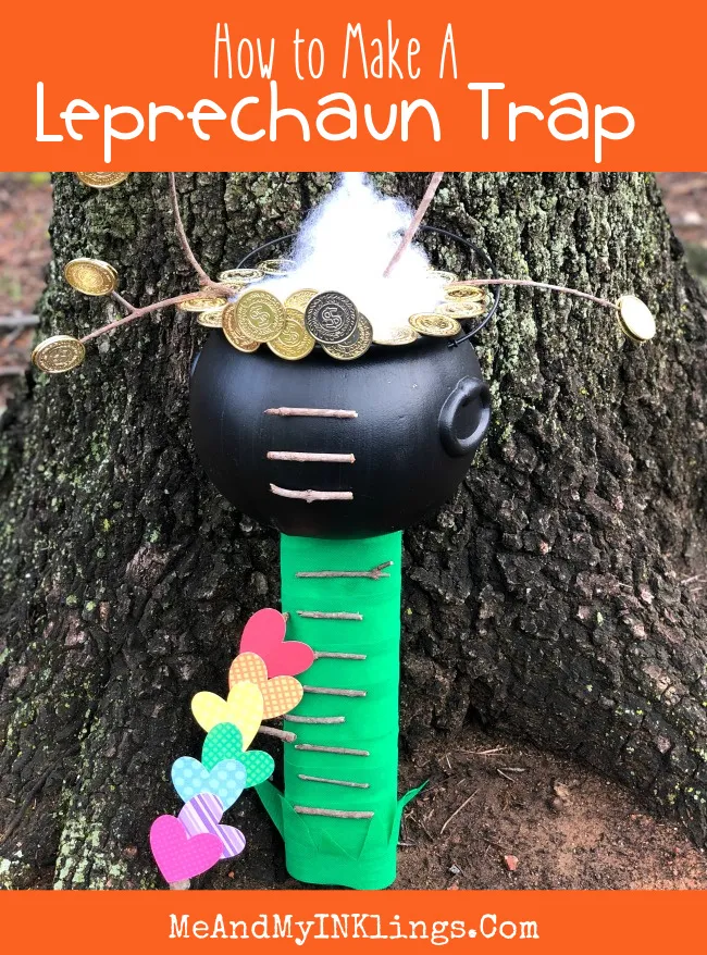 Simple St Patrick's Day craft for kids featuring a leprechaun trap with gold coins, rainbow hearts, stick ladder, and black pot.