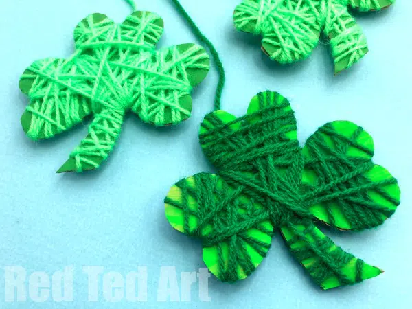 Examples of yarn wrapped shamrock crafts for St. Patrick's Day fun.