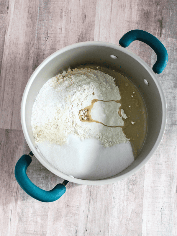Large cooking pot with ingredients for easy homemade playdough recipe.