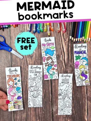 Woman holding examples of free printable mermaid bookmarks to color with crayons, glitter gel pens, color pencils, and scissors in background.