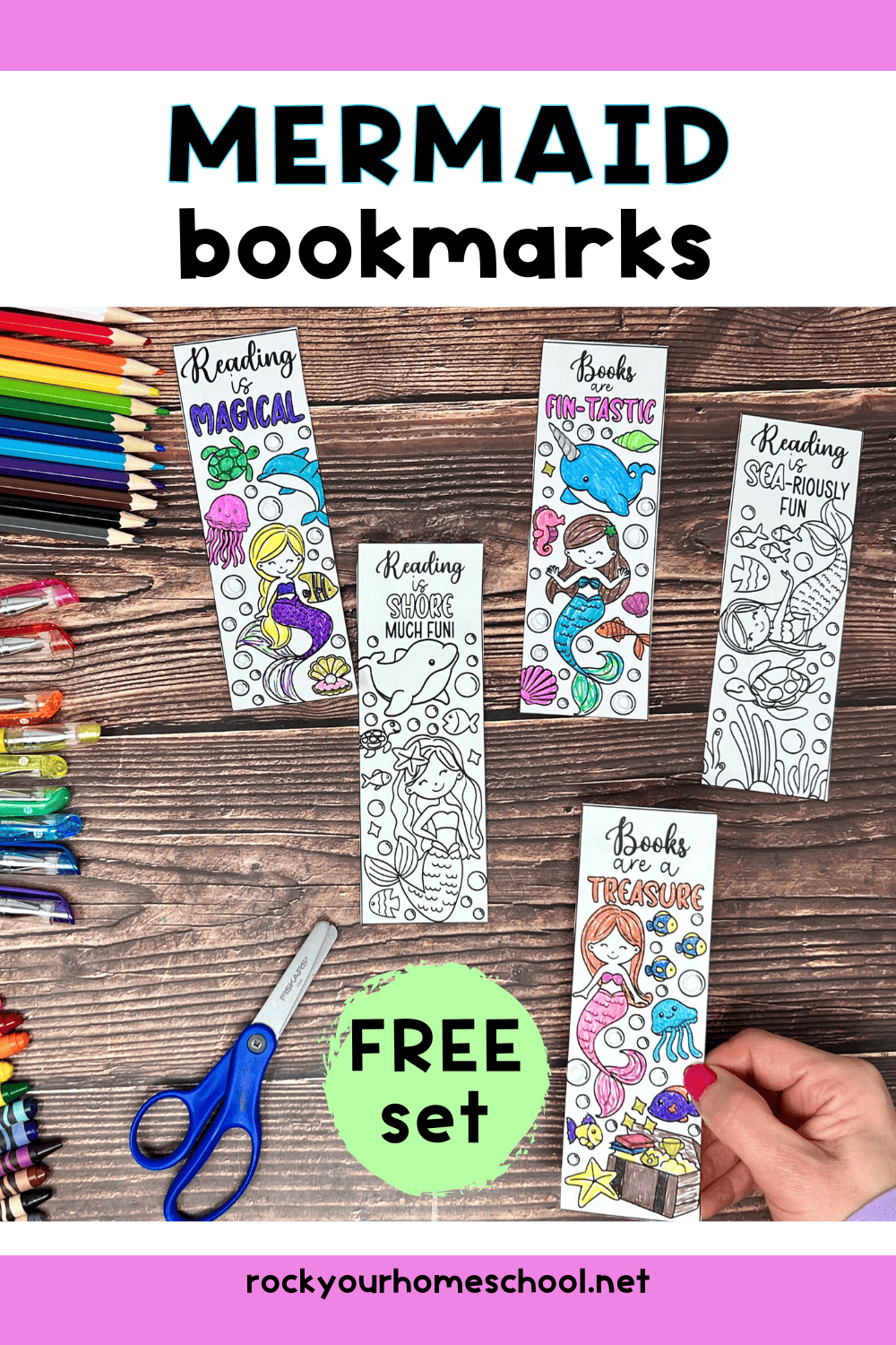 Woman holding an example of free printable mermaid bookmark to color with other examples in background and scissors, crayons, glitter gel pens, and color pencils.