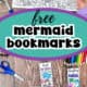 Woman holding page of black-and-white mermaid bookmarks and examples of free printable mermaid bookmarks to color with crayons, glitter gel pens, color pencils, and scissors in background.