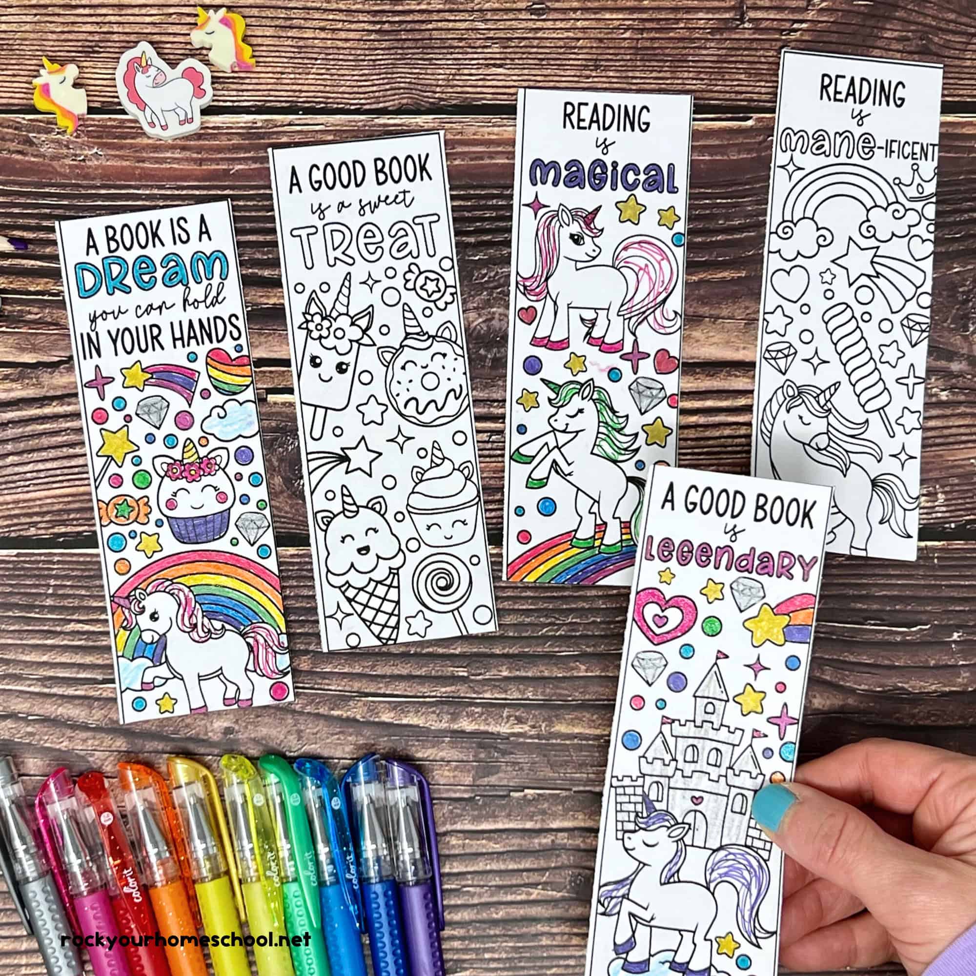 Woman with examples of free printable unicorn bookmarks to color with gel pens.