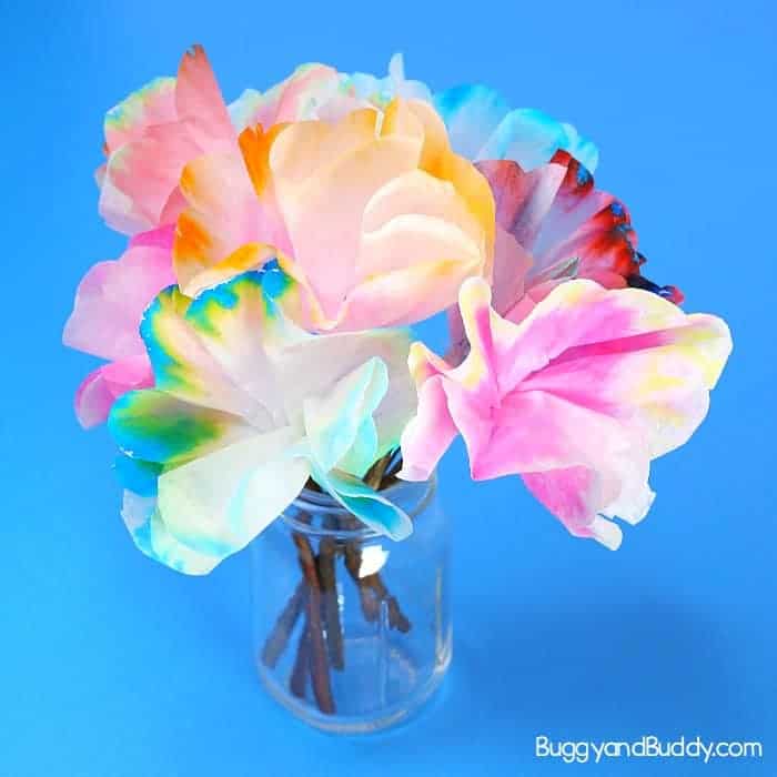 Examples of chromatography flowers made with coffee filters, water, and markers in glass jar.