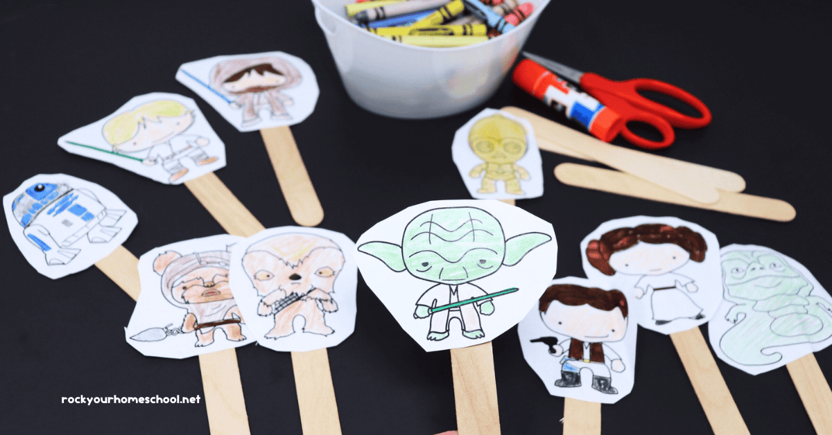 Examples of the small sizes of Star Wars coloring pages glued on wood craft sticks with glue stick, scissors, and crayons.