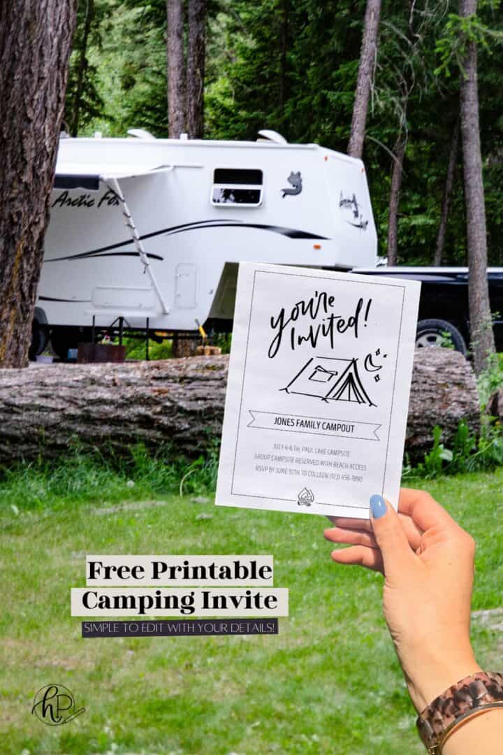 Woman holding example of free printable hand lettered invitation for a camping party.