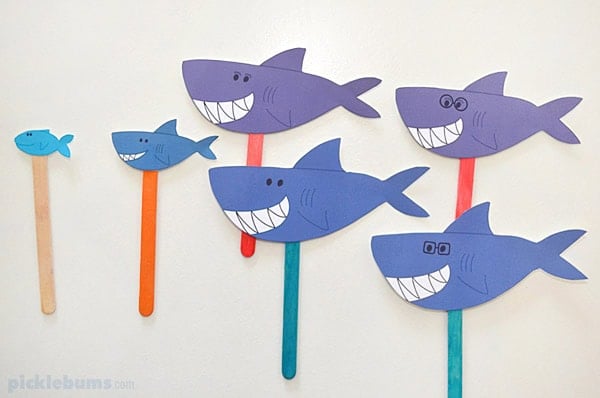 Examples of big and small printable shark puppets on wood craft sticks.