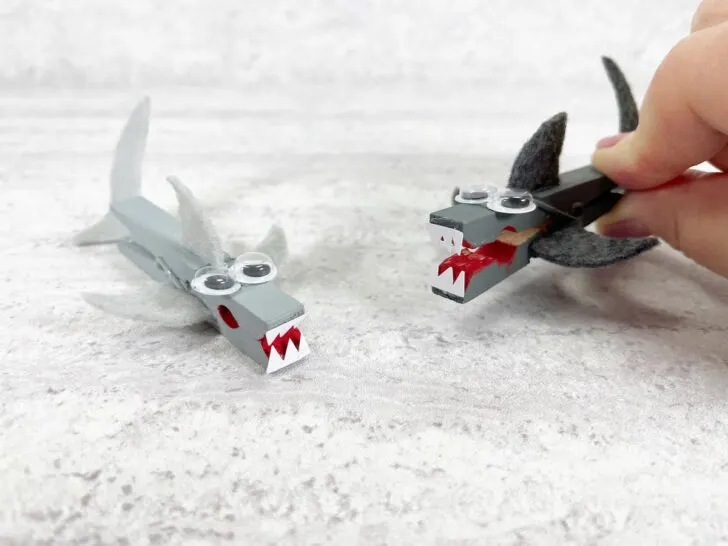 Two examples of shark clothespin craft.