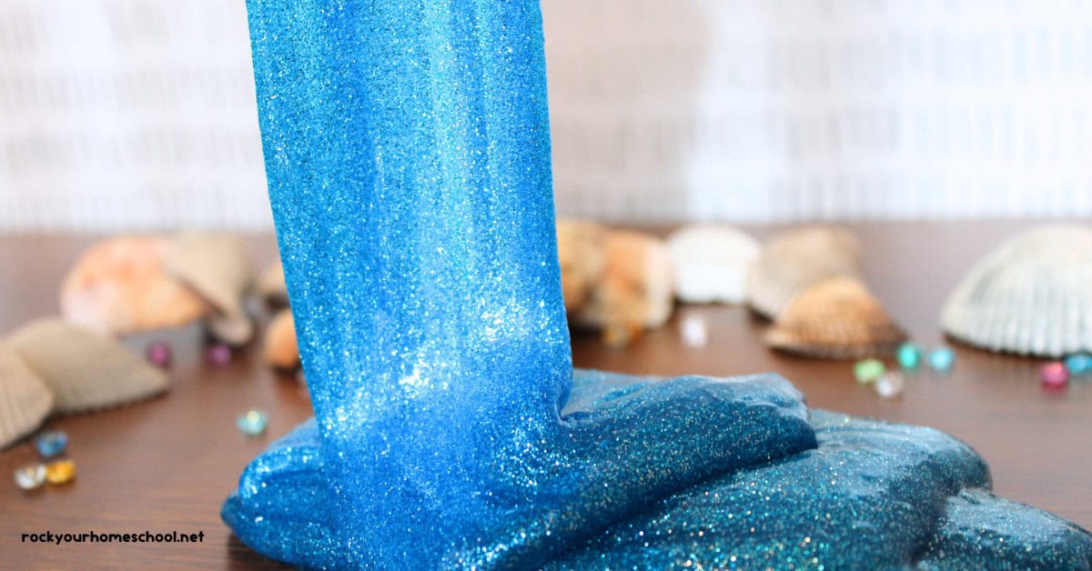 Example of DIY ocean slime recipe for kids with shells and gems in background.