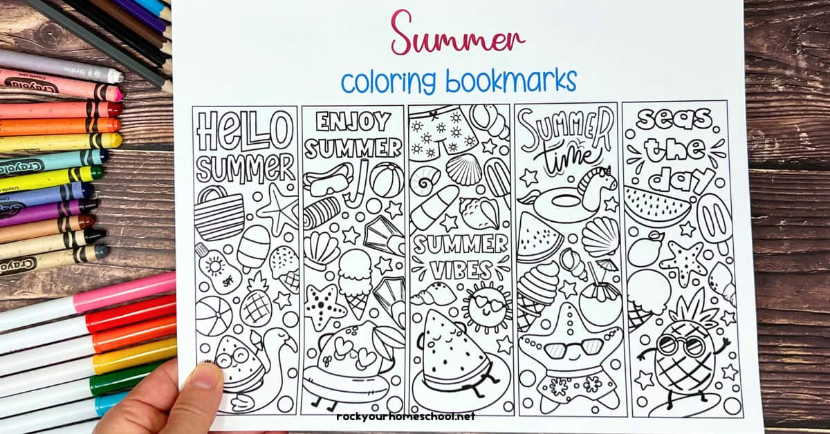 Woman holding example of page for summer coloring bookmarks.