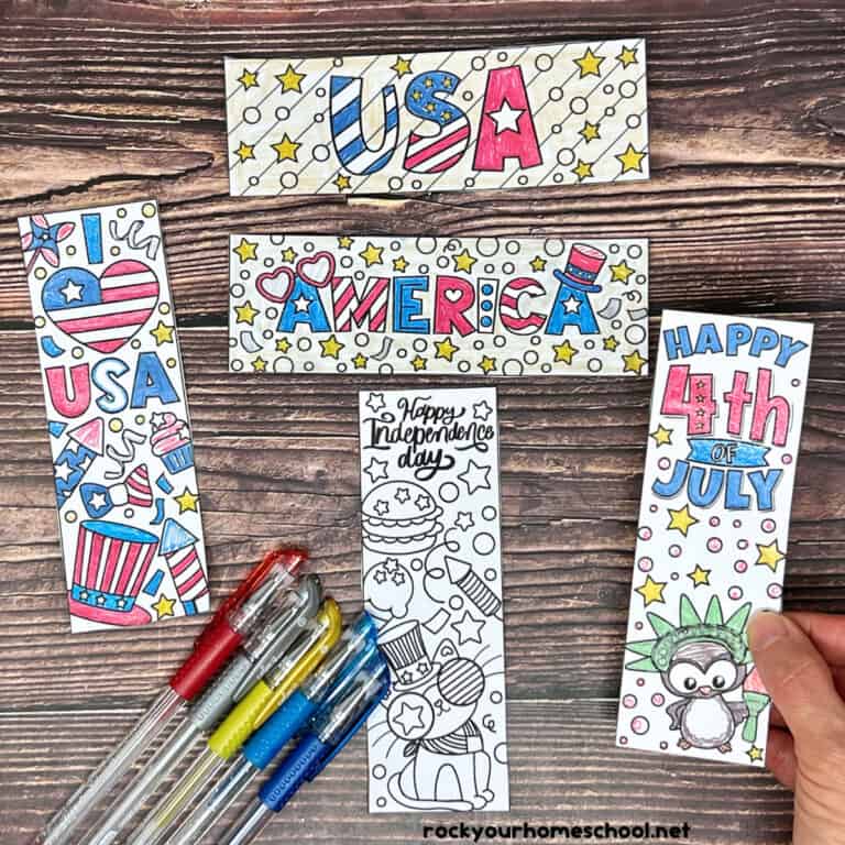 Woman holding example of free printable 4th of July coloring bookmarks with gel pens.