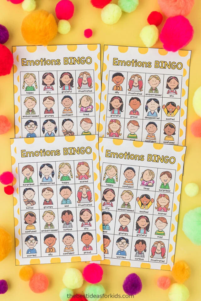 Four examples of emotions bingo game cards with pom poms.