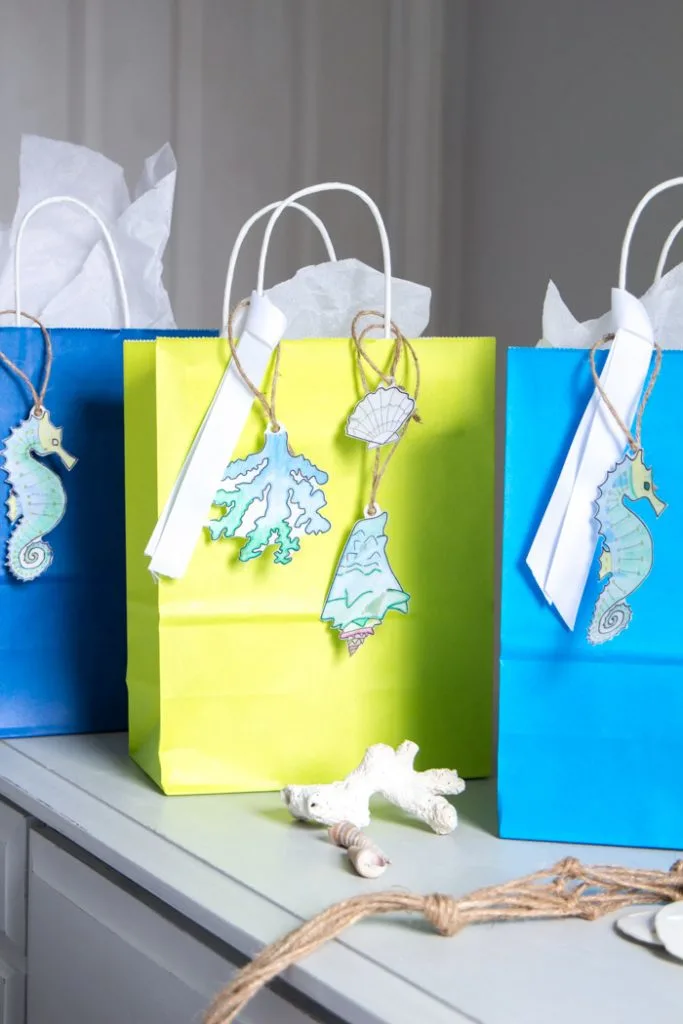 Three gift bags with free printable ocean-themed gift tags.