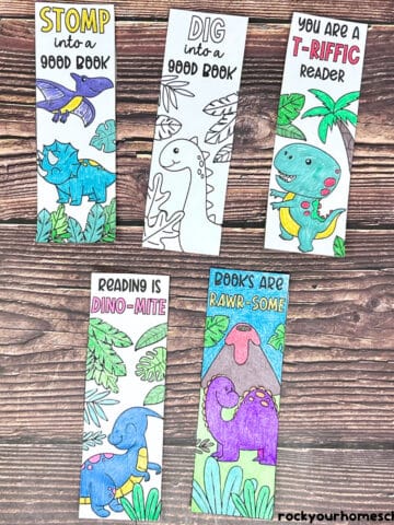 Five examples of free printable dinosaur bookmarks to color.
