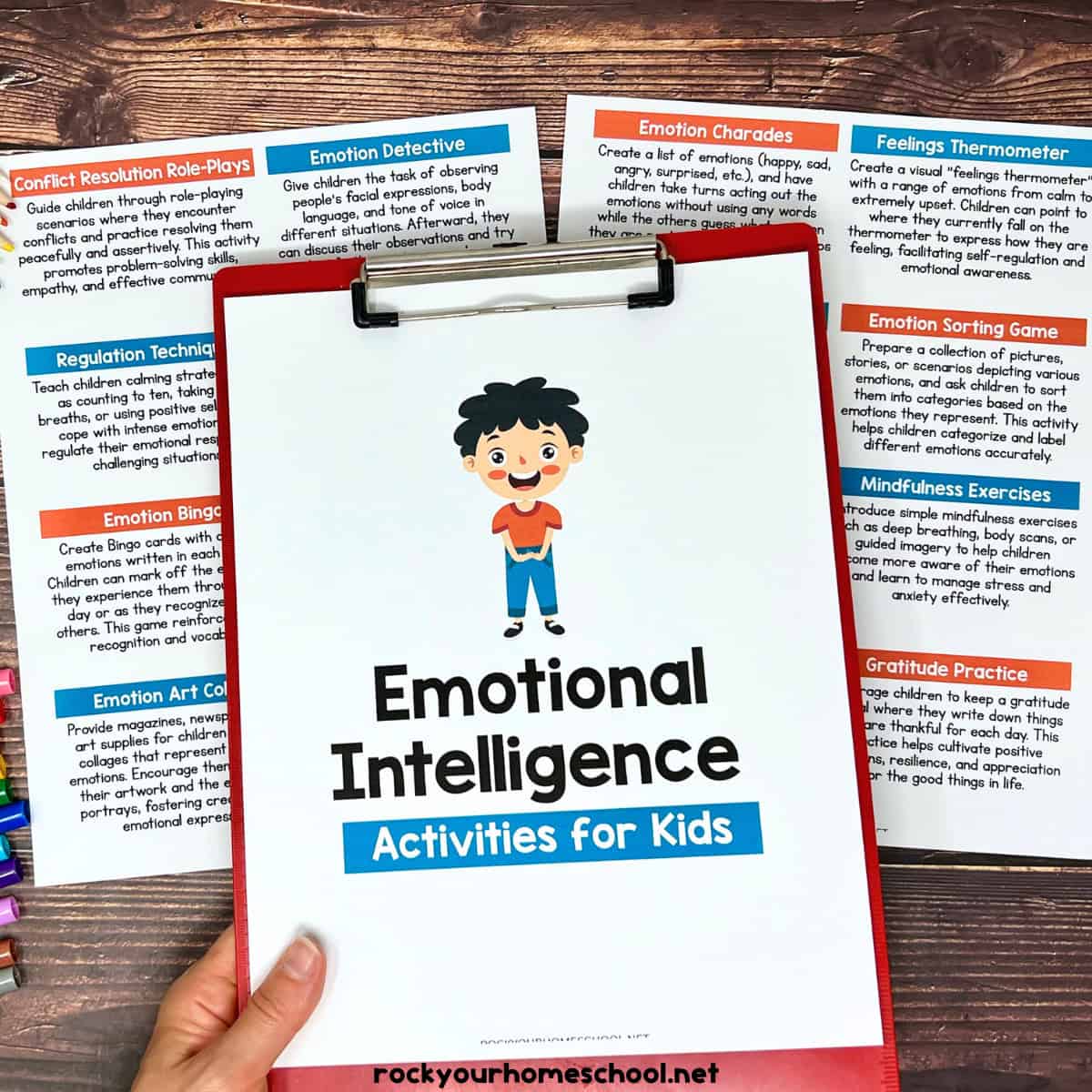 Woman holding clipboard with cover of emotional intelligence activities for kids pack with lists in background.