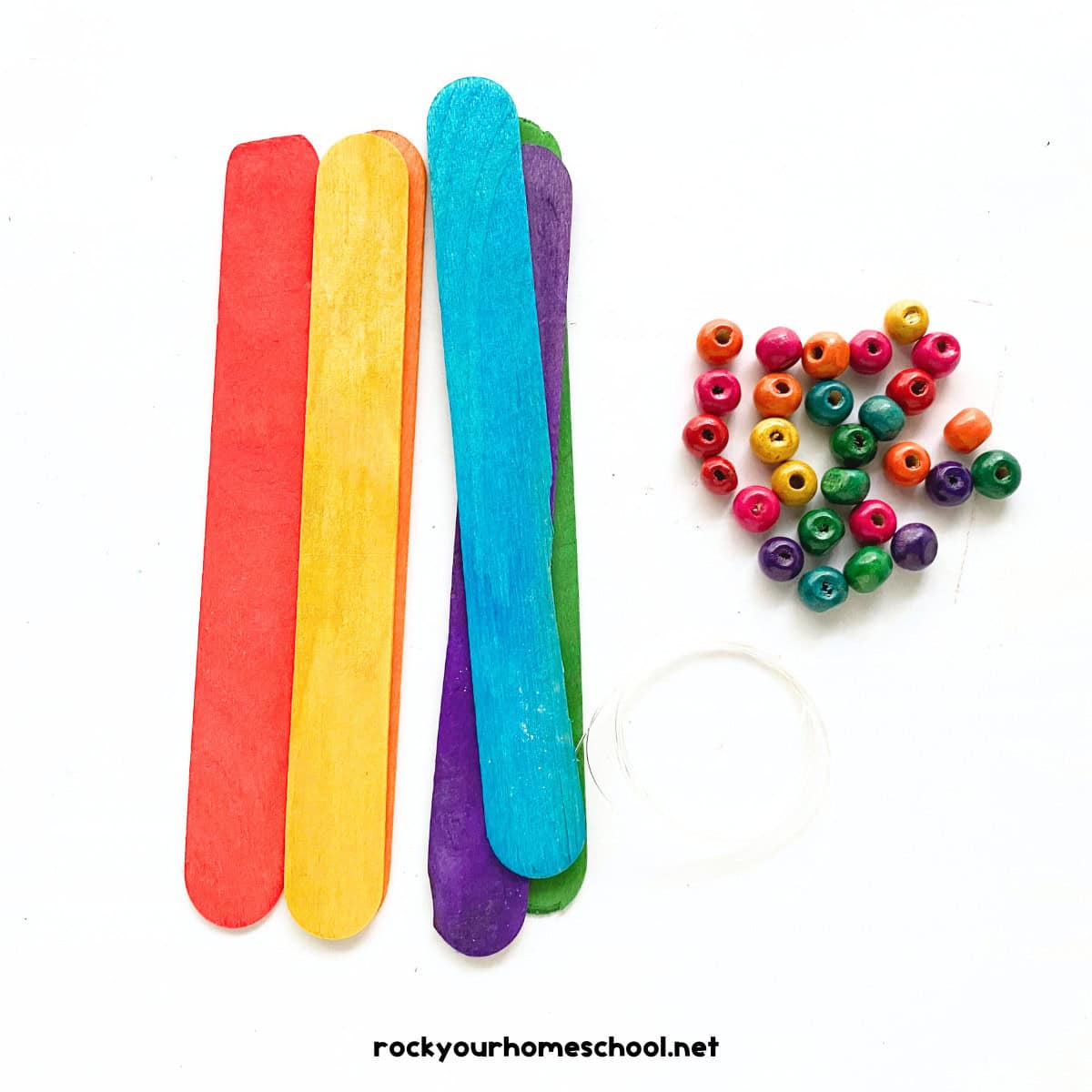 Popsicle sticks in rainbow of colors with wood beads and clear string.