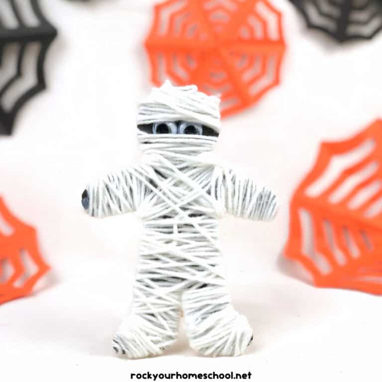 Yarn-wrapped mummy craft for kids.