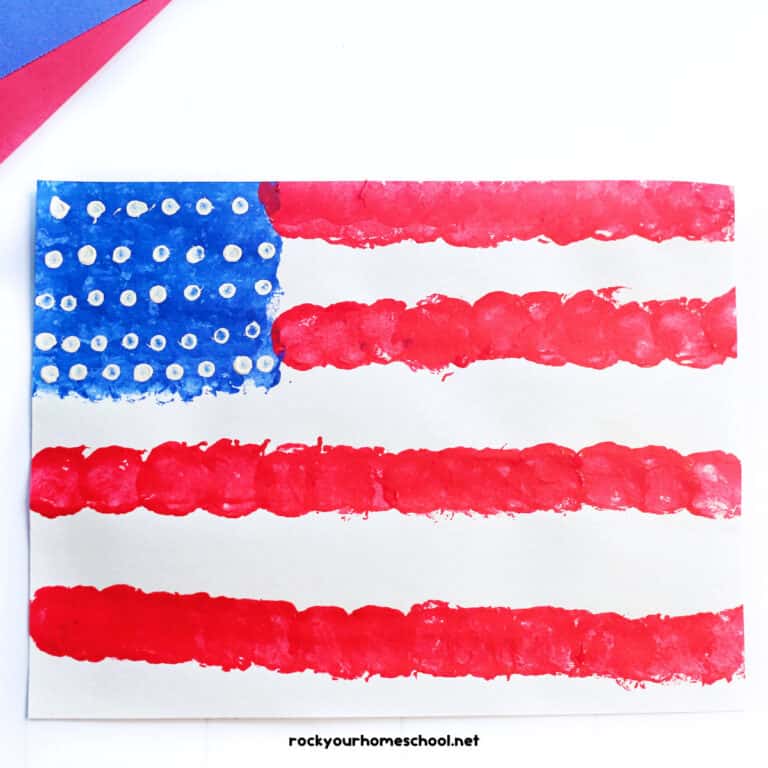 Example of easy American flag craft featuring a painting activity with red, white, and blue paint and uses cotton balls and Q-tips.