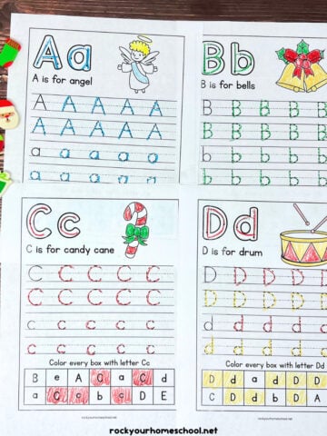 Four printable Christmas handwriting worksheets featuring the letters A, B, C, and D with mini erasers, crayons, and color pencils.