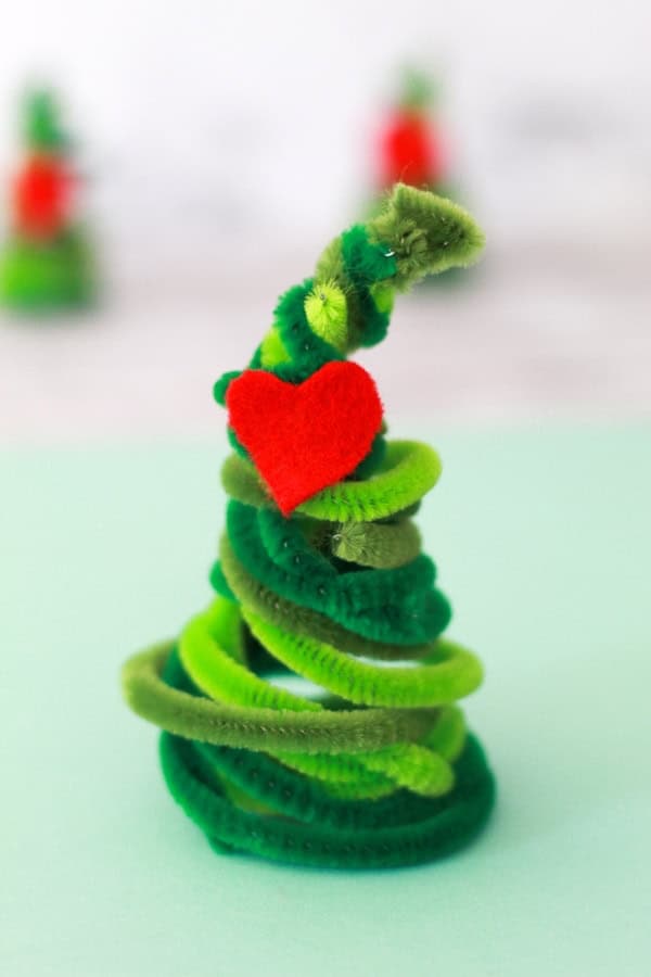 Example of DIY Grinch pipe cleaner Christmas tree with red felt heart.