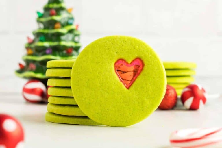 Examples of Grinch cookies with stained glass hearts.