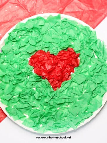 Example of easy Grinch paper plate craft made with red and green tissue paper.