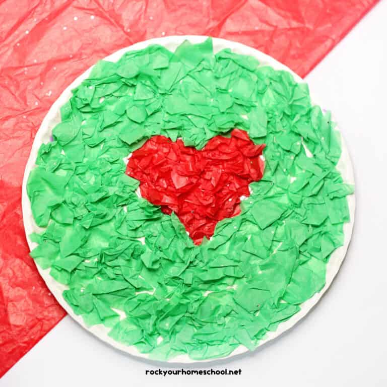 Example of easy Grinch paper plate craft made with red and green tissue paper.