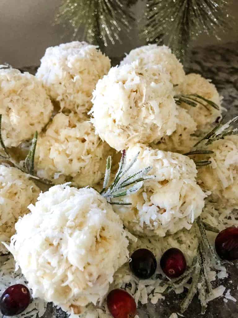 Examples of snowball popcorn balls with cranberries and pine.