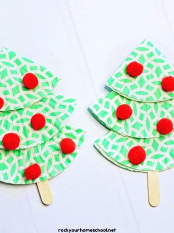 2 examples of cupcake liner Christmas tree crafts in green and white with popsicle stick and red pom poms.