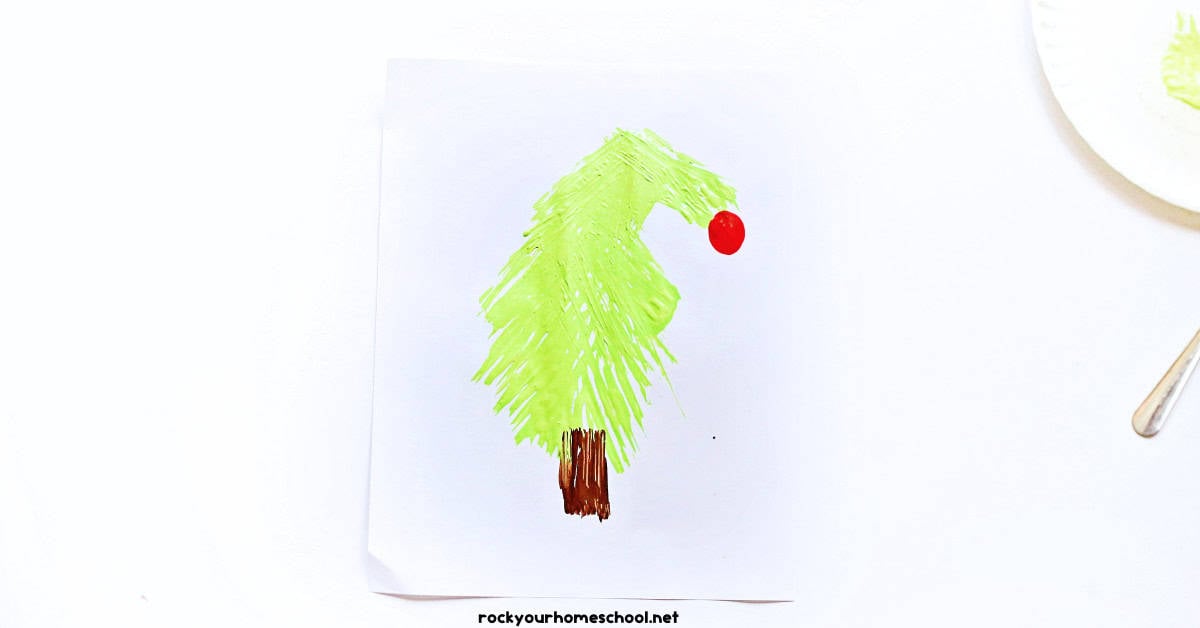 Example of Christmas tree made with green paint on fork and brown paint for trunk with red thumbprint top.