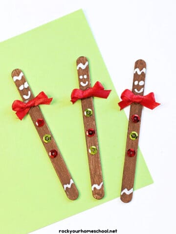 3 examples of easy gingerbread man crafts made with popsicle sticks, paint, ribbons, and sequins.