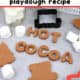 Hot chocolate playdough with cookie cutters, marshmallows, and in letters of H O T C O C O A.