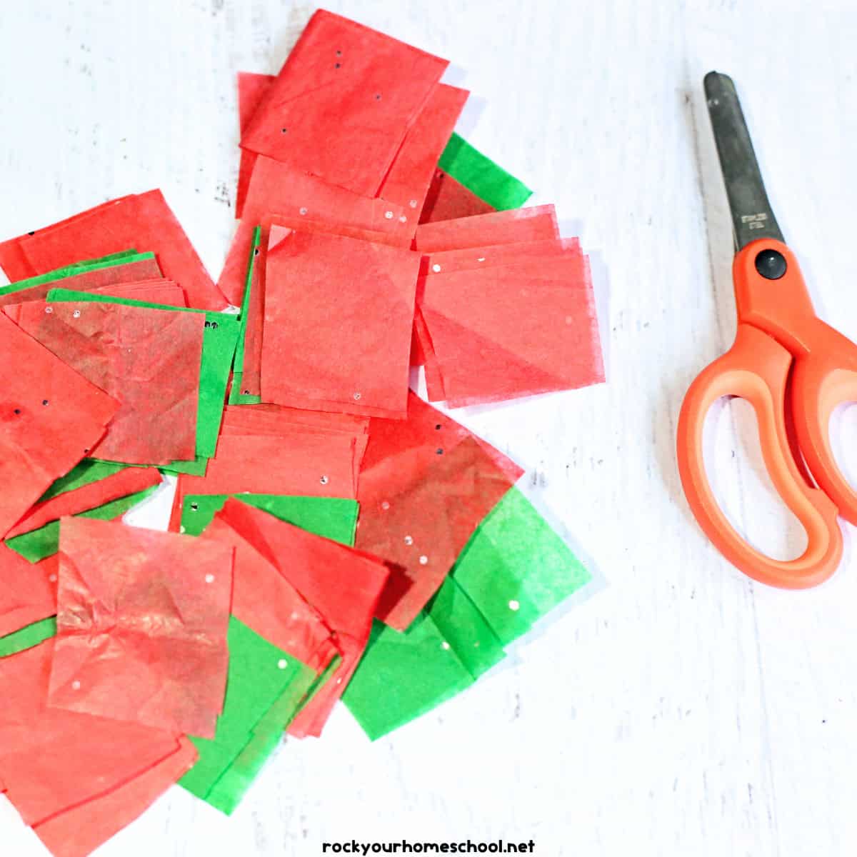 Red and green sparkle tissue paper with scissors.