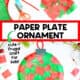 Red and green tissue paper squares, black construction paper, red pipe cleaner, glue stick, scissors, and paper plate with example of ornament craft.