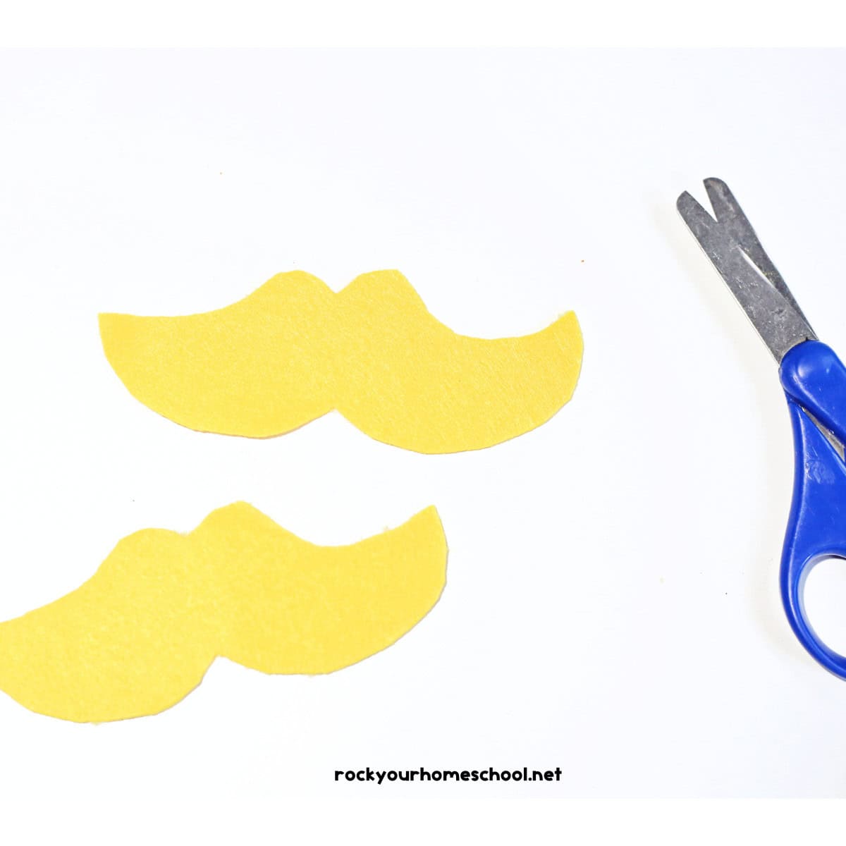 Two yellow mustache shapes with scissors.