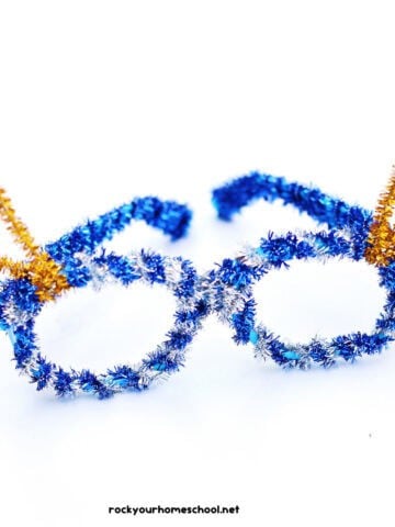 Example of DIY New Year's Eve glasses craft for kids with blue, silver, and gold pipe cleaners.